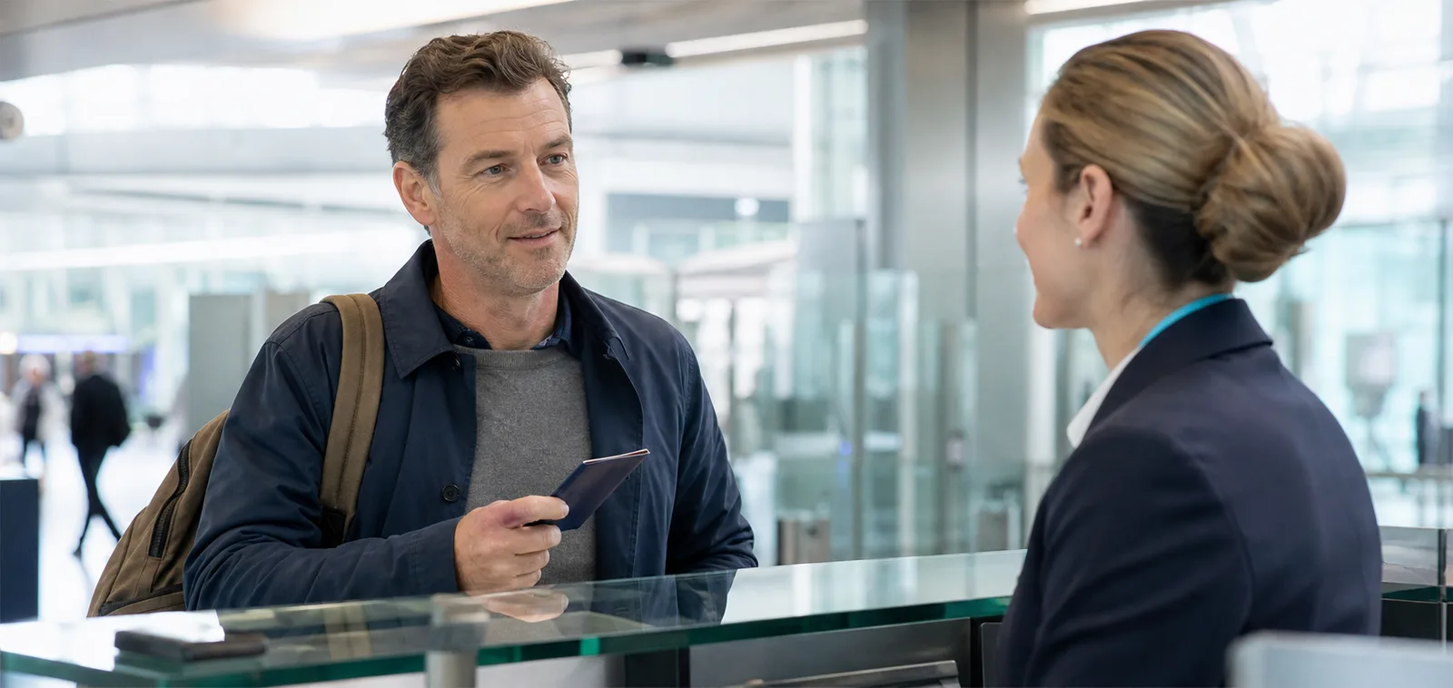 A traveller answering a passport-control officer at an airport